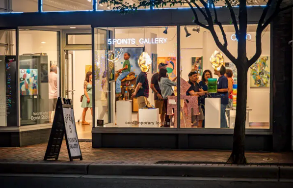 Bustling downtown Durham street scene with illuminated string lights